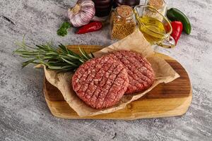 Raw burger cutlet for grill photo