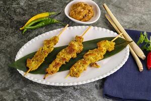 Thai meat skewer Satay with sauce photo