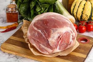 Uncooked raw pork knuckle with spices photo