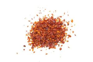 Chilli pepper flakes isolated on a white background. Top view, flat lay. photo