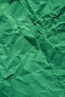 Crumpled green paper texture background photo