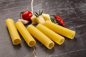 Raw uncooked Italian pasta Cannelloni photo