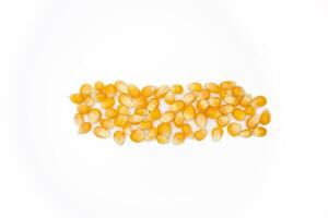 Dried corn kernels isolated on white background. Top view, flat lay. photo