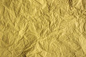 Crumpled yellow paper texture background photo