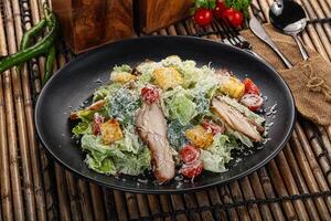 Caesar salad with chicken and romano photo