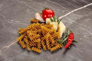 Raw whole grain pasta fusilli photo