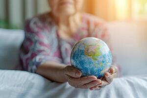 AI generated Elderly Asian patient with globe symbolizes health in hospital. photo