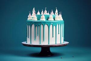 White birthday cake with teal ganache on dark blue background. photo