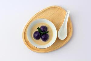 Kolak Candil Ubi Ungu or Purple Sweet Potato Balls with Palm Sugar and Coconut Milk Sauce. photo