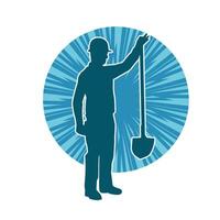 Silhouette of a worker carrying shovel tool. Silhouette of a worker in action pose using shovel tool. vector