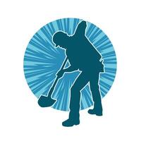 Silhouette of a worker carrying shovel tool. Silhouette of a worker in action pose using shovel tool. vector