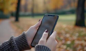 AI generated Female hand holding smartphone with blank screen on nature background. Mock up photo