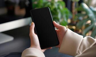 AI generated Mockup image of female hands holding black mobile phone with blank screen photo