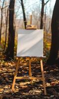 AI generated Wooden easel with blank canvas standing in the autumn forest. photo