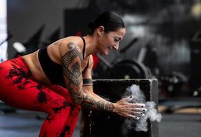 Dust in hands of a woman about to lift weights photo