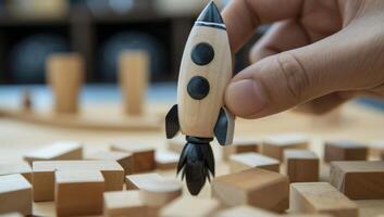 AI generated Hand holding wooden toy rocket above scattered blocks photo