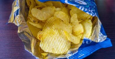 Potato chips with salt in open bag photo
