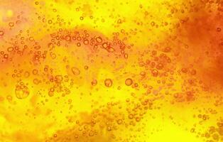 Abstract textured gel background. Yellow and orange liquid with bubbles. photo