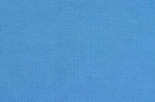 The texture of the fabric in blue color. Material for making shirts and blouses photo