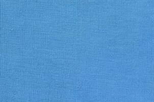 The texture of the fabric in blue color. Material for making shirts and blouses photo