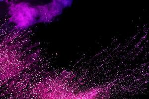 Abstract colorful powder explosion on black background.Freeze motion of dust splash.Painted Holi. photo