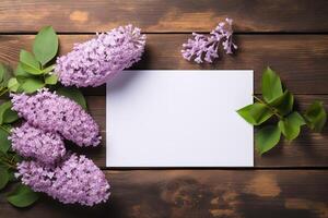 AI generated mockup white blank paper sheet with lilac flowers top view on brown wooden background, floral template empty card flat lay for design with copy space photo