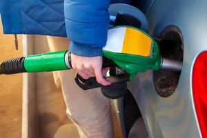 Refueling the car at a gas station fuel pump. photo