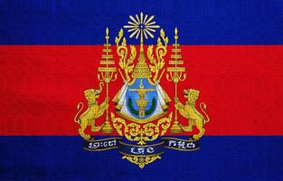 Flag and coat of arms of Kingdom of Cambodia on a textured background. Concept collage. photo