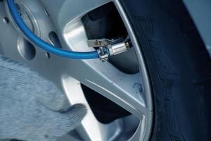 A pressure gauge that determines tire pressure. Tire inflation process. photo