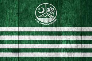 Flag of and coat Azad Kashmir on a textured background. Concept collage. photo