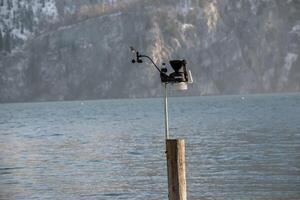 Lake Traunsee, Austria - 01.14.2024 Small weather station with cup anemometer and weathervane photo