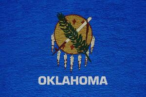 Flag of Oklahoma state USA on a textured background. Concept collage. photo