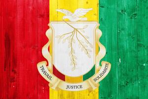 Flag and coat of arms of Republic of Guinea on a textured background. Concept collage. photo