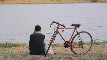 Man traveler with a backpack on a bike on a country road video