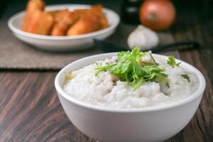 rice porridge or congee with minced pork and soft-boiled eggs photo