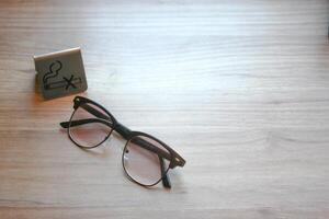 Eyeglasses and logo don't smoke on wood table with copy space for add text. photo