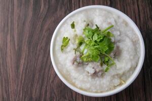 rice porridge or congee with minced pork and soft-boiled eggs photo