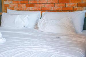 White pillows on the bed in the bedroom in the morning. photo