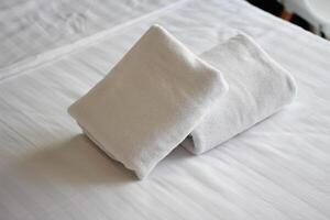 Clean towels on bed at hotel room and copy space. photo