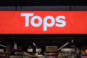 BANGKOK, THAILAND JULY 09, 2023 Tops Sign. Tops is a famous a grocery chain in Thailand that was founded in 1996. photo