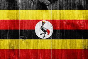 bandera de república de Uganda en un texturizado antecedentes. concepto collage. foto
