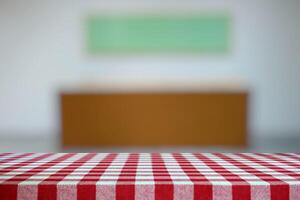 Empty Table Covered with Red Checkered Tablecloth and Blurred Art Gallery Hallway Background. photo