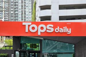 BANGKOK, THAILAND SEPTEMBER 13, 2023 Tops daily Sign. It is a famous supermarket in Bangkok, Thailand, Operated by The Mall Group co. photo