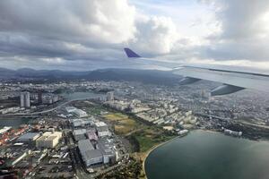 FUKUOKA, JAPAN  NOVEMBER 11, 2023 Airplane Wing over Fukuoka airport. It is a capital of Fukuoka Prefecture and the sixth-largest city in Japan. photo