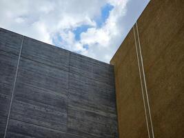 Minimal Building with White Cloud Blue Sky Background. photo