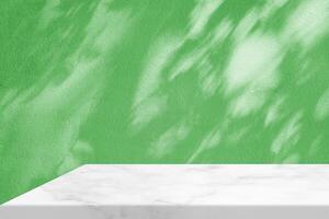 Minimal White Marble Table Corner with Shadow and Warm Light Beam on Medium Dark Green Concrete Wall Background, Suitable for Product Presentation Backdrop, Display, and Mock up. photo