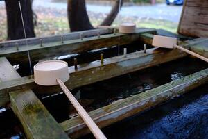 Japanese Holy Water Dipper in front of Hokkaido shrine Mikado where is a tourist attraction in Sapporo, Japan. photo