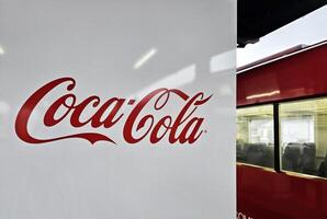 YUFUIN, JAPAN  NOVEMBER 12, 2023 Coca Cola sign on vending machine at Yufuin station. The Coca-Cola Company, American corporation founded in 1892. photo