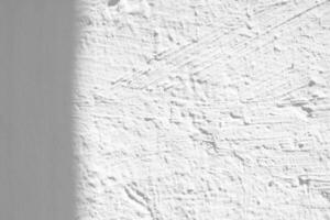 Shadow on Plaster Stucco Wall Texture Background, Suitable for Overlay, Product Presentation, Backdrop and Mockup. photo