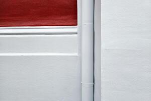 Minimal White and Red Painting Concrete with Drain Pipe Background. photo